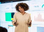 A woman shares Power BI data projected for a presentation