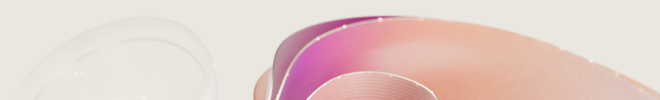 Abstract curled ribbon and a translucent glass sphere in magenta, peach and blush pink on a light.
